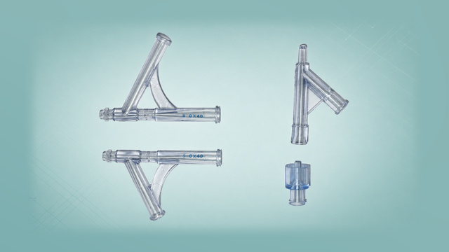Transparent Y-manifold and Y-connector configurations, a one-piece Y-manifold, and a blue Luer cap on a Polymerex teal-green background